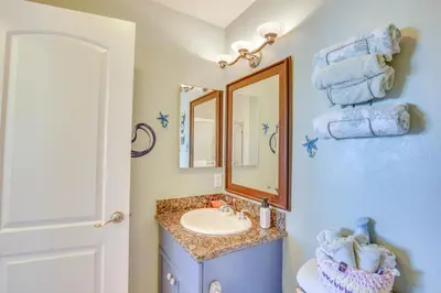 a bathroom with a sink and a mirror at Sunny Imperial Beach Condo - Walk to Ocean! in Imperial Beach