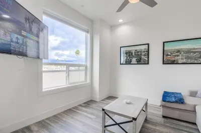 a living room with a couch and a large window at Park Blvd 301 - Modern - Urban Oasis - SPA in San Diego