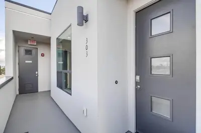 a hallway with a blue door in a building at Park Blvd Paradise 303 king bed With a private Spa in San Diego