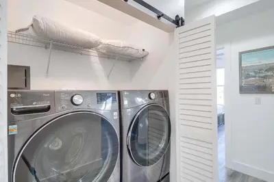 a washer and dryer in a laundry room at Park Blvd Paradise 304 New construction, king bed! in San Diego