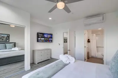 a white bedroom with a bed and a ceiling fan at Park Blvd Paradise 304 New construction, king bed! in San Diego