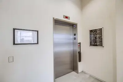 an elevator in a building with a sign on the wall at Park Blvd Paradise 304 New construction, king bed! in San Diego