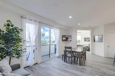 a dining room with a table and chairs and a window at Park Blvd Paradise 304 New construction, king bed! in San Diego
