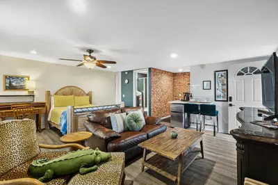 a living room with a couch and a table at Mile to Beach! Tiki Master Suite in Oceanside