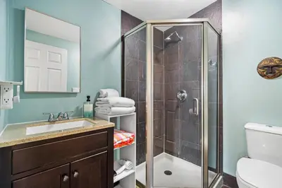 a bathroom with a shower and a sink at Mile to Beach! Tiki Master Suite in Oceanside