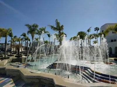 a water fountain in a park with palm trees at Mile to Beach! Tiki Master Suite in Oceanside