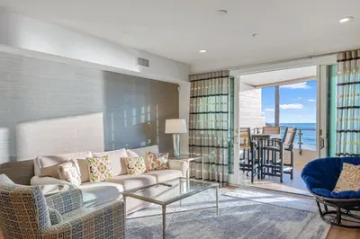 a living room with a couch and a table and chairs at Escape to Neptune in San Diego