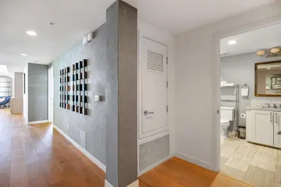 a hallway of a home with a white and gray wall at Escape to Neptune in San Diego