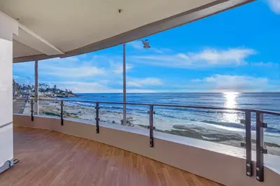 a room with a balcony with a view of the ocean at Escape to Neptune in San Diego