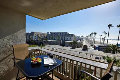 a table with a bowl of fruit on a balcony at Oceanfront condo at North Coast Village in Oceanside