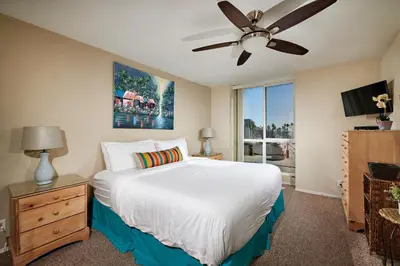 a bedroom with a bed and a ceiling fan at Oceanfront condo at North Coast Village in Oceanside