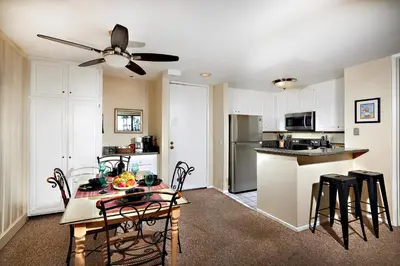 a kitchen and dining room with a table and chairs at Oceanfront condo at North Coast Village in Oceanside