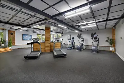 a gym with treadmills and ellipticals in a room at Oceanfront condo at North Coast Village in Oceanside