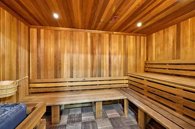 a sauna with wooden paneling and a bench in it at Oceanfront condo at North Coast Village in Oceanside