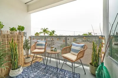 a balcony with three chairs and a table and some plants at Luxury 2BD 2BA, BRAND NEW/PETS/CLOSE TO EVERYTHING/BOHO+COZY VIBES in San Diego