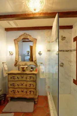 a bathroom with a sink and a shower with a mirror at Vineyard Hacienda in El Cajon