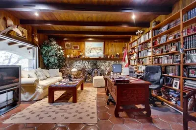 a living room with a library with bookshelves at Vineyard Hacienda in El Cajon
