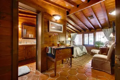 a bedroom with a bed and a desk in a room at Vineyard Hacienda in El Cajon