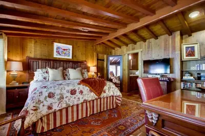 a bedroom with a bed and a desk and a television at Vineyard Hacienda in El Cajon