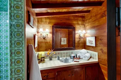 a bathroom with a sink and a mirror at Vineyard Hacienda in El Cajon