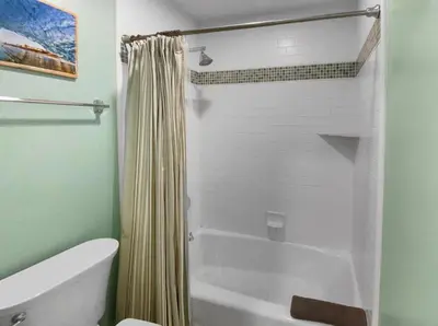 a bathroom with a tub and a shower curtain at Massive Mission Beach Home - Fire Pit & Deck in San Diego