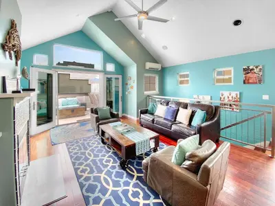 a living room with two couches and a table at Massive Mission Beach Home - Fire Pit & Deck in San Diego