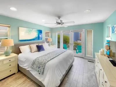a bedroom with a large bed and blue walls at Massive Mission Beach Home - Fire Pit & Deck in San Diego