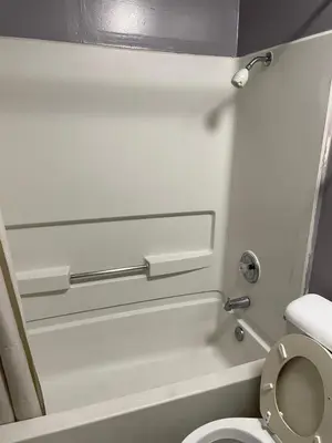 a small bathroom with a toilet in an airplane at Valley Motel El Cajon San Diego in El Cajon