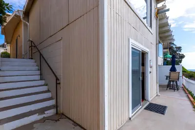 a building with a staircase next to a door at Ocean Bluff Hideaway Unit B in San Clemente