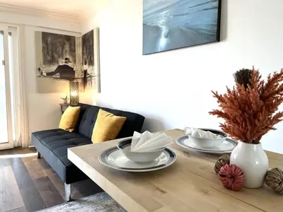a living room with a table and a couch at Ocean Bluff Hideaway Unit B in San Clemente
