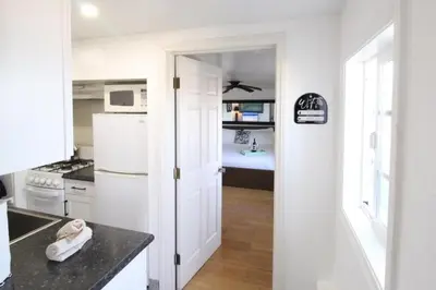 a kitchen with a white refrigerator and a sink at Ocean Bluff Hideaway Unit B in San Clemente
