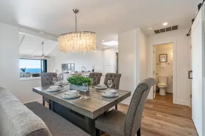 a dining room and living room with a table and chairs at CBS-2369 - Cardiff Panoramic Paradise in Cardiff-by-the-Sea