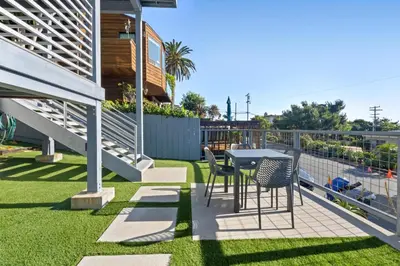 a patio with a table and chairs on the grass at CBS-2369 - Cardiff Panoramic Paradise in Cardiff-by-the-Sea