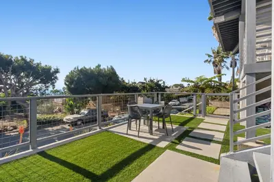 a balcony with grass and a table and chairs at CBS-2369 - Cardiff Panoramic Paradise in Cardiff-by-the-Sea