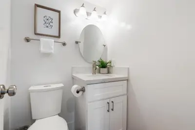a bathroom with a white toilet and a mirror at CBS-2369 - Cardiff Panoramic Paradise in Cardiff-by-the-Sea