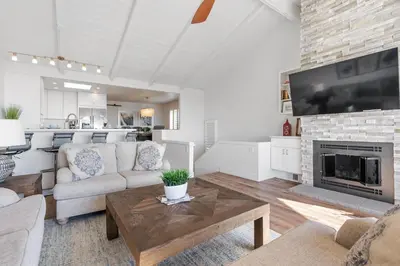 a living room with a couch and a fireplace at CBS-2369 - Cardiff Panoramic Paradise in Cardiff-by-the-Sea