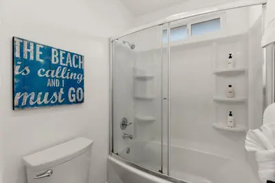 a white bathroom with a shower and a toilet at CB-3900A - Coastal Carlsbad Surfer's Dream in Carlsbad