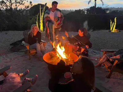 a group of people sitting around a campfire at Private Hacienda with Heated Pool and Spa with Amazing Views in Del Mar