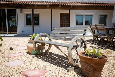 a wooden bench sitting in front of a house at Private Hacienda with Heated Pool and Spa with Amazing Views in Del Mar