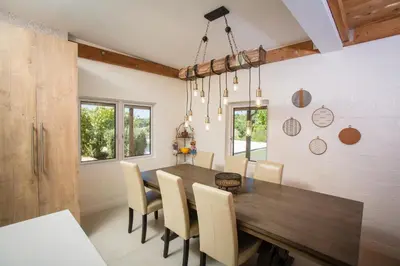 a dining room with a wooden table and chairs at Private Hacienda with Heated Pool and Spa with Amazing Views in Del Mar
