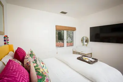 a living room with a white couch and a television at Private Hacienda with Heated Pool and Spa with Amazing Views in Del Mar