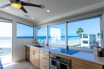 a kitchen with a view of the beach at Ocean view, two-level condo with stunning view, decks, fast WiFi & fireplace in San Diego