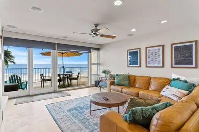 a living room with a couch and a table at A Wave From It All in Carlsbad