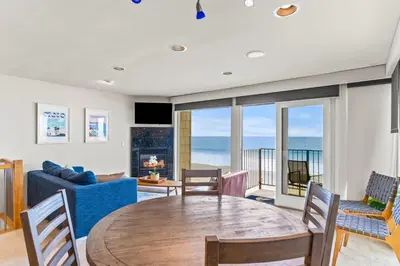 a living room with a table and a couch at A Wave From It All in Carlsbad