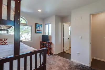 a bedroom with a bunk bed and a doorway at Bay View Dream - Steps to Bay, Rooftop Patio & AC in San Diego