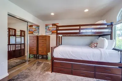 a bedroom with a large bed and a mirror at Bay View Dream - Steps to Bay, Rooftop Patio & AC in San Diego