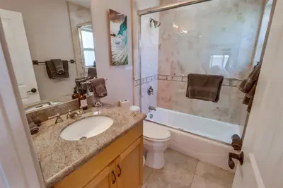 a bathroom with a sink and a toilet and a shower at Bay View Dream Home - IndoorOutdoor Living, Rooftop & Steps to Bay in San Diego