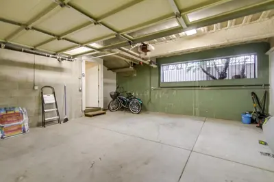 an empty garage with two motorcycles parked in it at Bay View Dream Home - IndoorOutdoor Living, Rooftop & Steps to Bay in San Diego