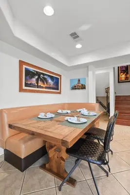 a dining room with a wooden table and chairs at Bay View Dream Home - IndoorOutdoor Living, Rooftop & Steps to Bay in San Diego
