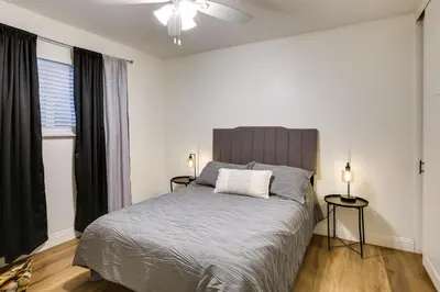 a bedroom with a large bed and a window at Spacious Home with Yard about 7 Mi to Dtwm San Diego! in San Diego